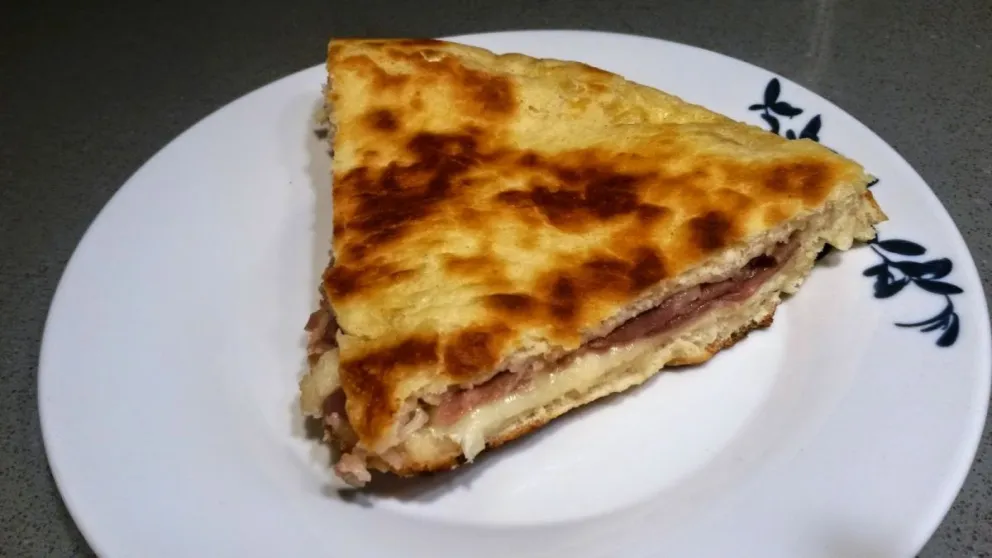 Receta de pizza rellena con jamón y queso: una delicia para compartir en reuniones